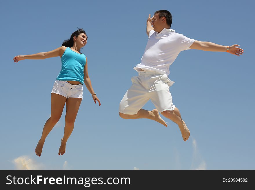 Young Man And Woman Jumping