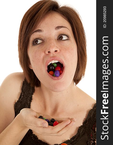 A woman with a mouth and handful of jelly beans. A woman with a mouth and handful of jelly beans.