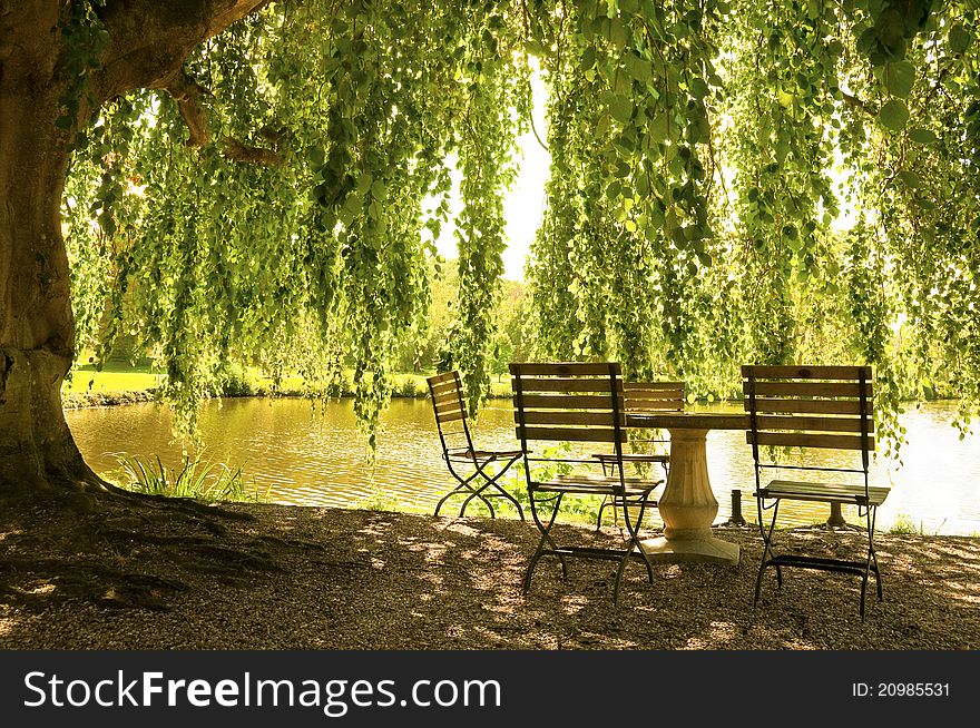 Stone table and chairs next to a pond