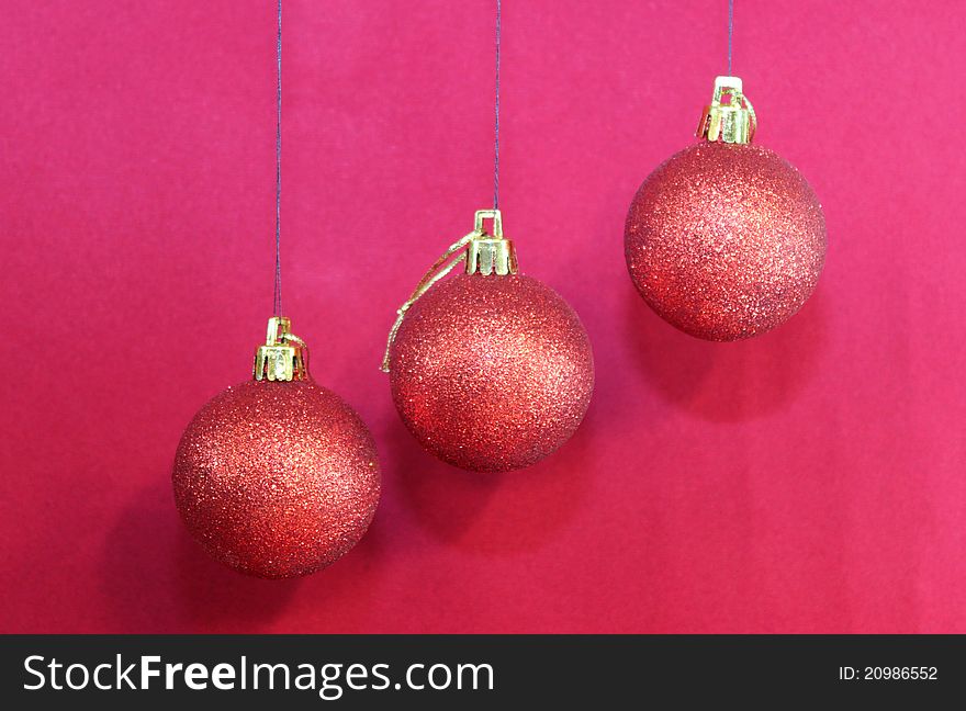 Christmas decorations with red balls on red background. Christmas decorations with red balls on red background