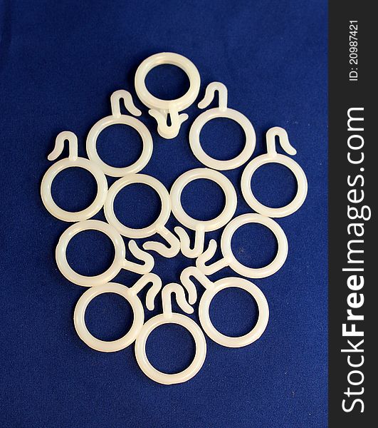 Designing of white plastic curtain rings on blue background. Designing of white plastic curtain rings on blue background