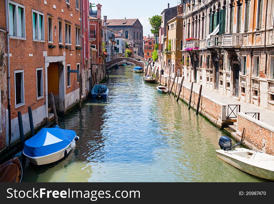 Canal, boats and bridge in Venice