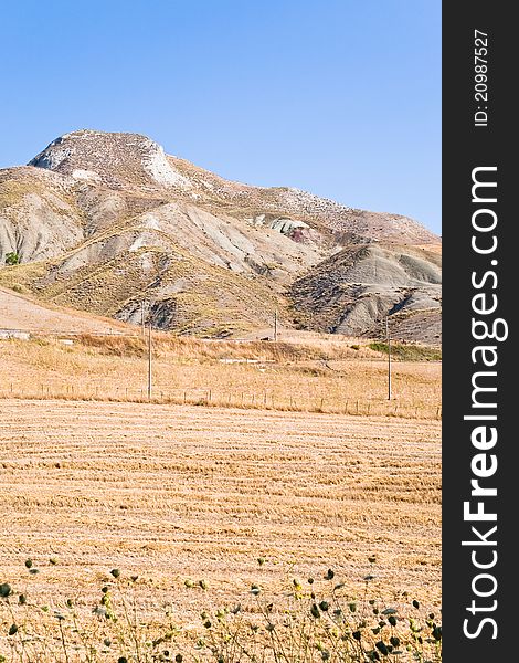 Deserted sicilian landscape in hot summer day