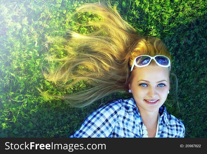 Young happy girl lie on meadow