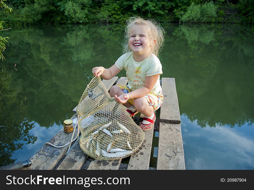 The girl on fishing rejoices that has fished. The girl on fishing rejoices that has fished