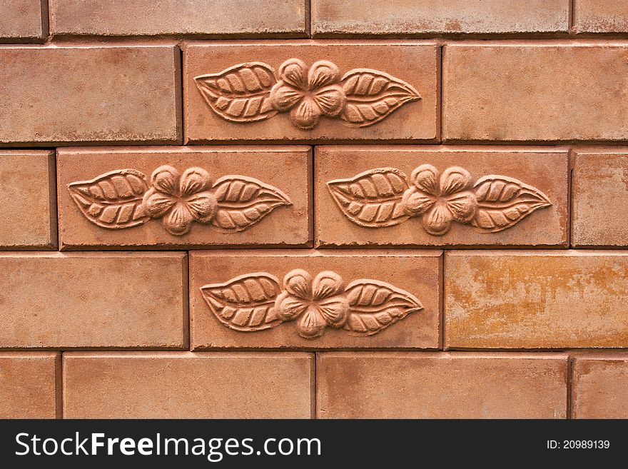 Flower and leaf on brick wall