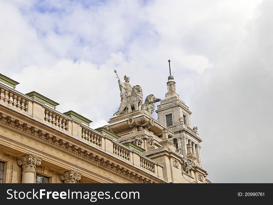 An ornate Statue of a Regal Woman and Lions on a historic building in Yorkshire. An ornate Statue of a Regal Woman and Lions on a historic building in Yorkshire