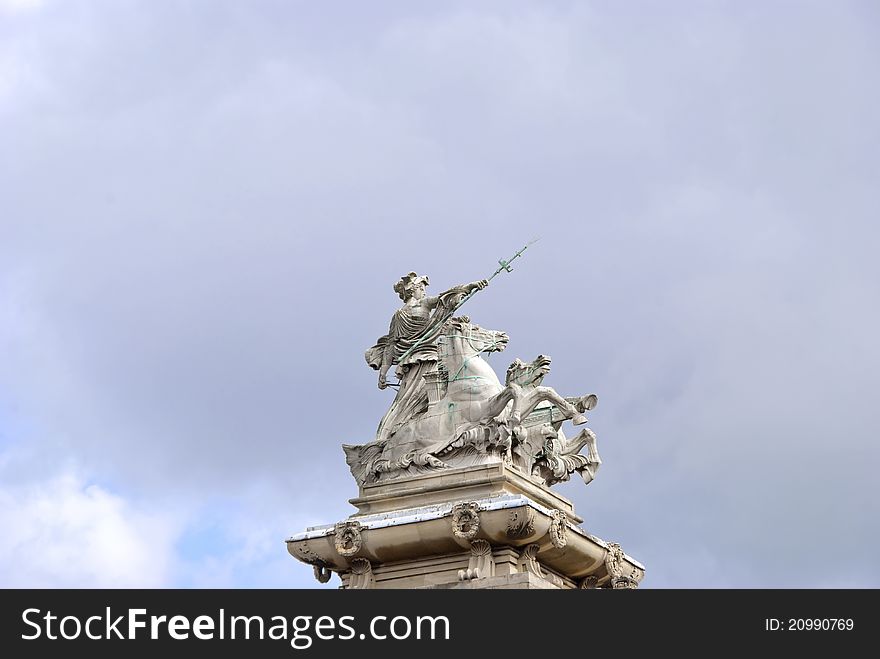 A Statue of a Woman in a Horse Drawn Chariot holding a Trident. A Statue of a Woman in a Horse Drawn Chariot holding a Trident