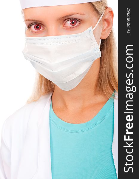 Face of a young doctor in a protective mask, close-up with red eyes