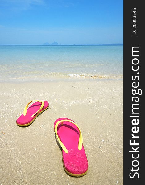 Pink sandals on the beautiful beach