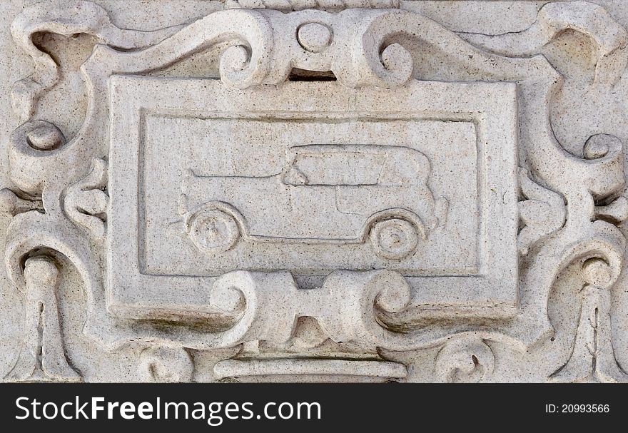 Details of carved wall decoration with classic car