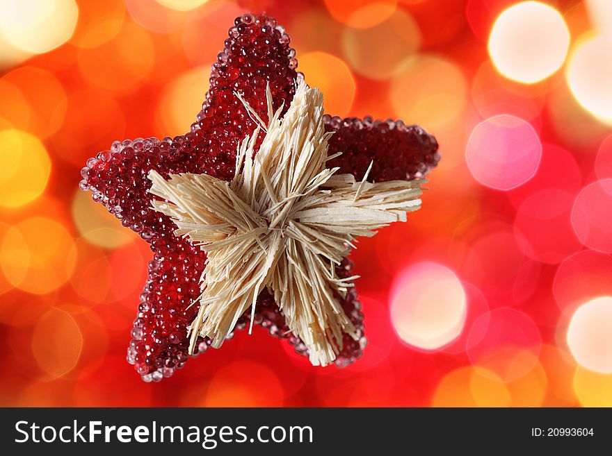 Star Christmas decoration against red blurred background