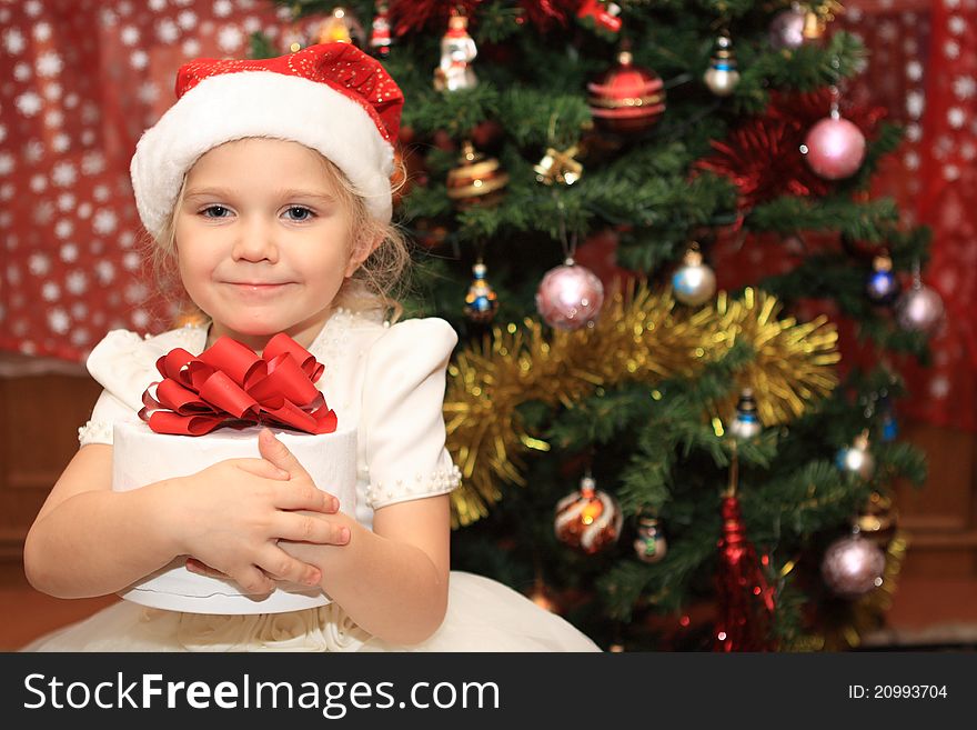 The Little  Girl With A Present Near Fir-tree