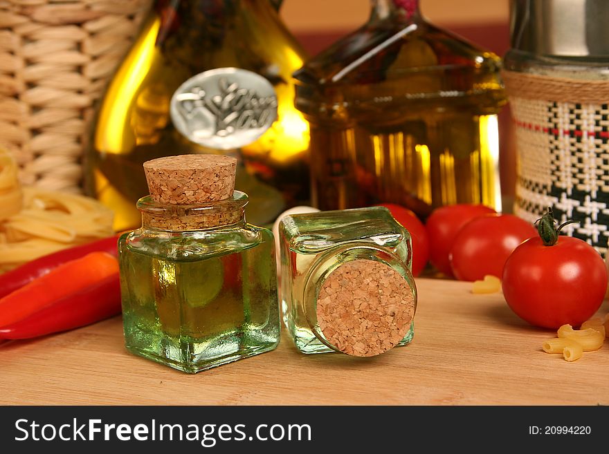 Fresh vegetables and olive oil on table