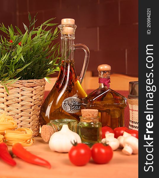 Fresh vegetables, macaroni and olive oil on table