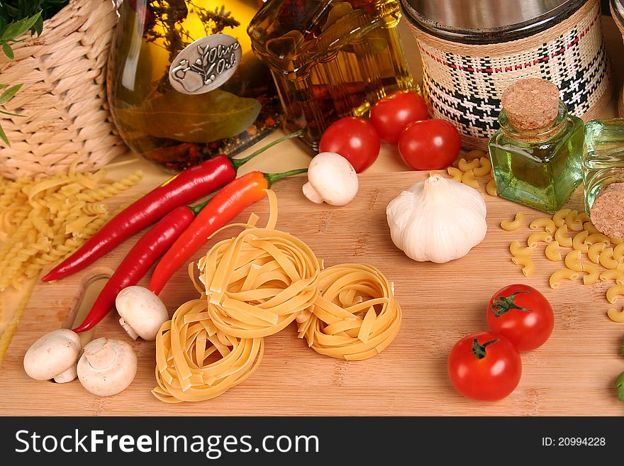 Fresh vegetables, macaroni and olive oil on table. Fresh vegetables, macaroni and olive oil on table