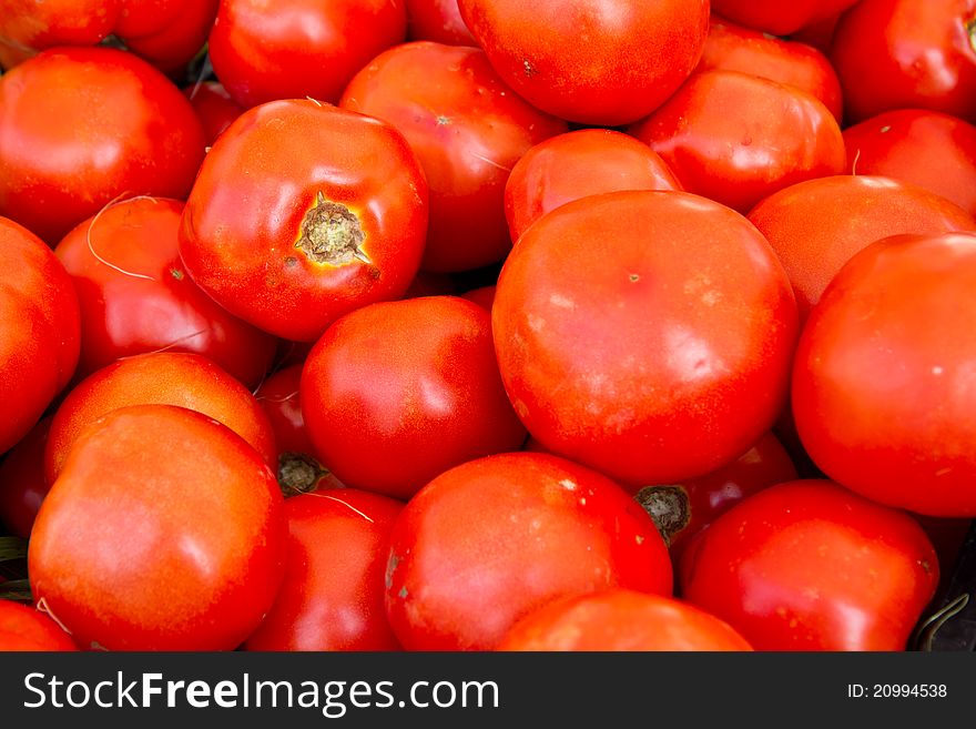 Loose red tomatoes for sale at a farmer's market
