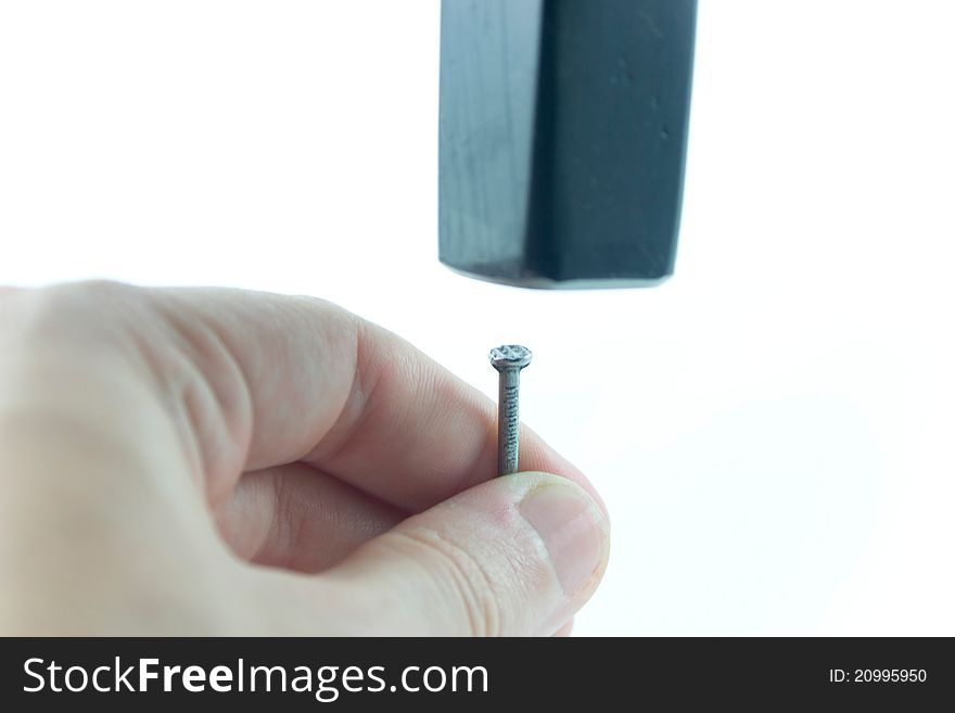 Closeup photo of nail and hammer
