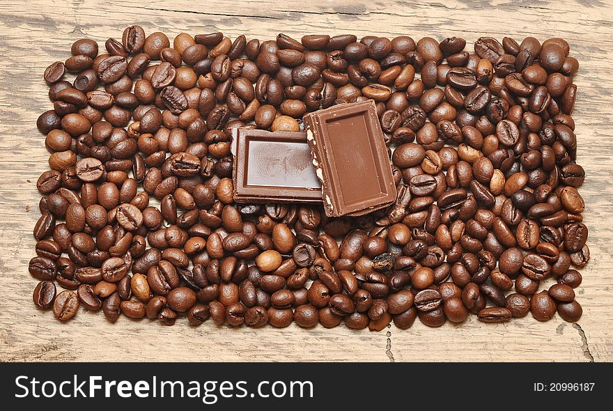 Coffee bean and chocolate on wood background