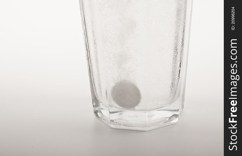 Glass of water with dropped sparkling fizzy tablet. Glass of water with dropped sparkling fizzy tablet