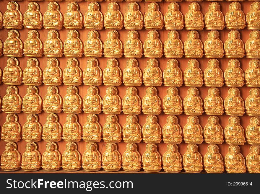 Golden buddha on wooden wall