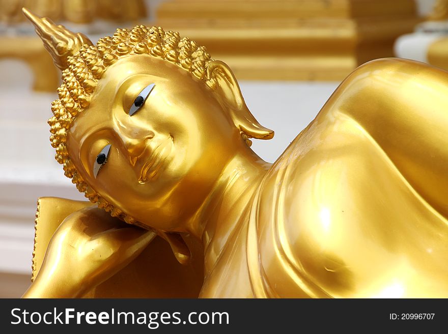 Reclining Buddha image in front of church, Wat Naga Wichai, Mahasarakam, Thailand