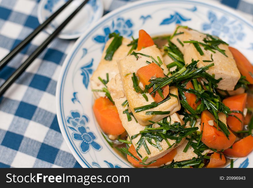 Simple fried bean curd dish topped with Chinese spring onions. Simple fried bean curd dish topped with Chinese spring onions.