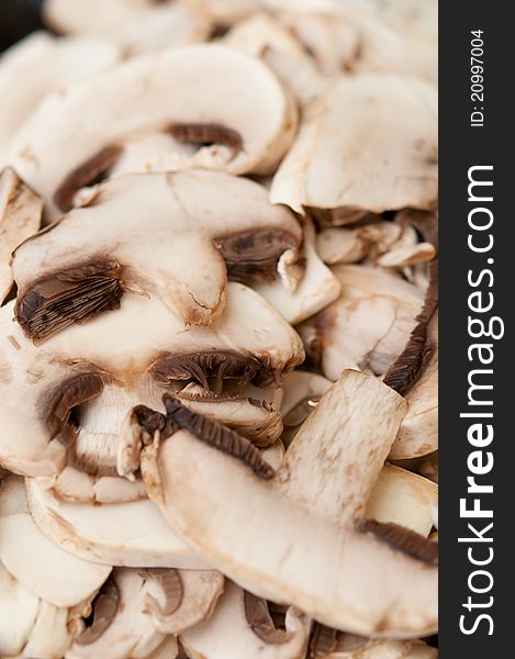 Washed and cut white button mushrooms as a food ingredient.