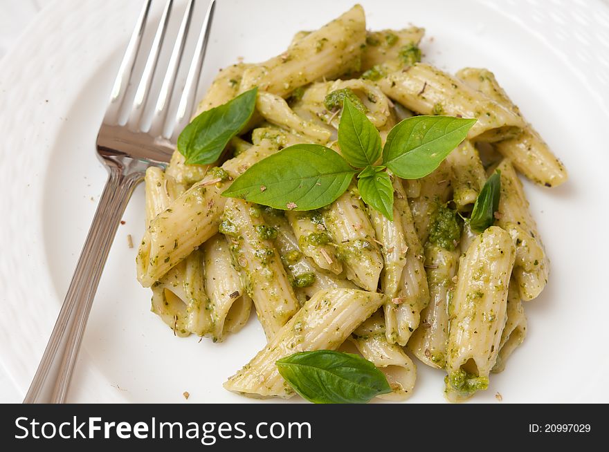 Macaroni mixed and prepared with delicious pesto sauce topped with spices. Macaroni mixed and prepared with delicious pesto sauce topped with spices.