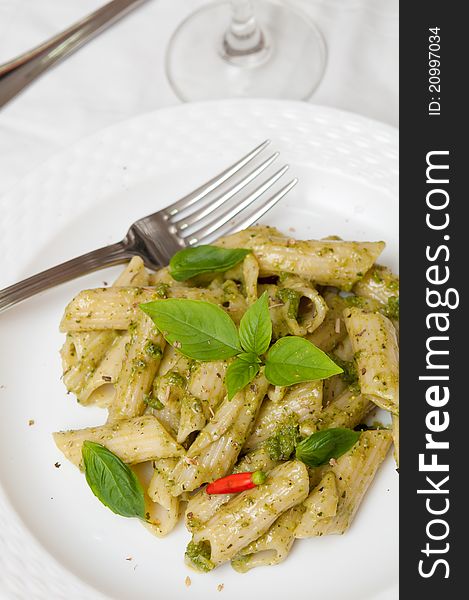 Special pasta cooked with green pesto sauce and finished with spices. Special pasta cooked with green pesto sauce and finished with spices.