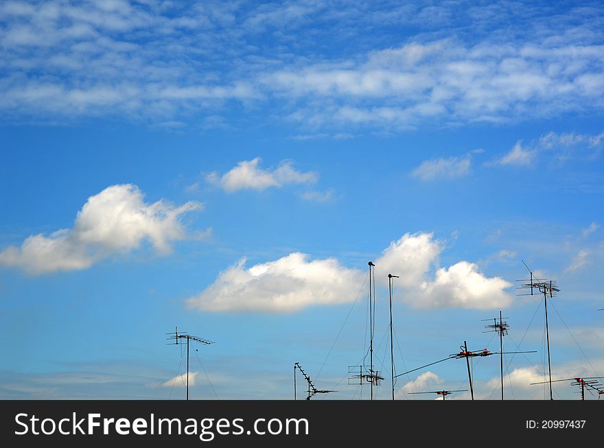 TV antenna on the roof with blue sky