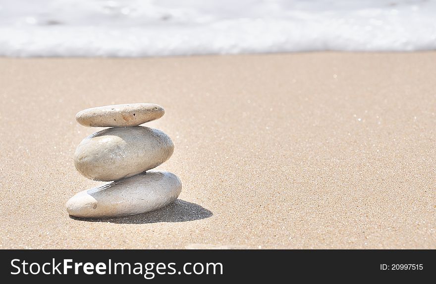 Stacked Pebbles In The Sand