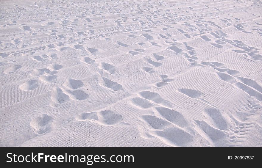 Footprints on white sand beach