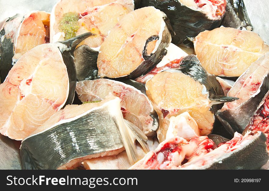 Fresh fish is cut into pieces. See red blood.