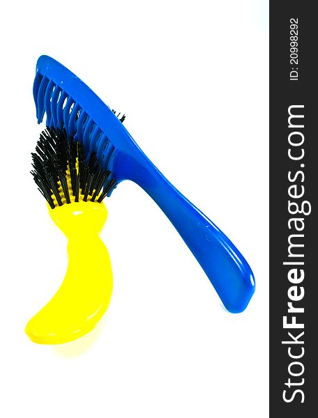 Comb, yellow and blue. Place isolated on white background. Comb, yellow and blue. Place isolated on white background.