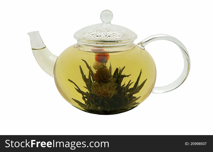 Flowering green tea in the glass teapot on white isolated macro shot