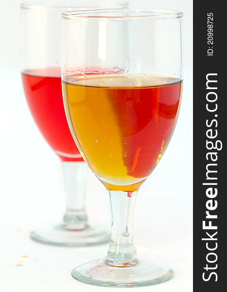 Isolated closeup of two glasses of red and white wines on white background. Isolated closeup of two glasses of red and white wines on white background
