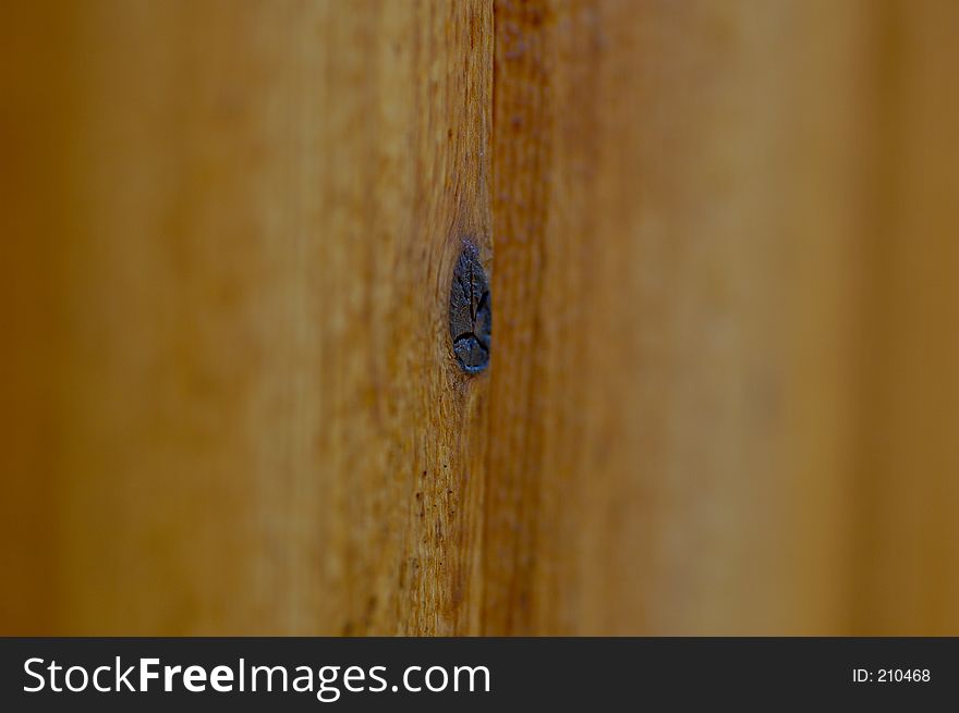A very selective focused shot of knot in a section of wood.