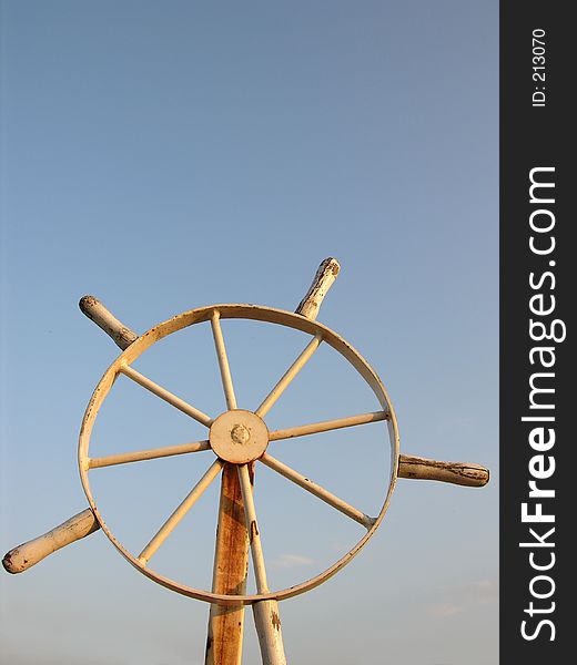 Old Steering Wheel And A Blue Sky