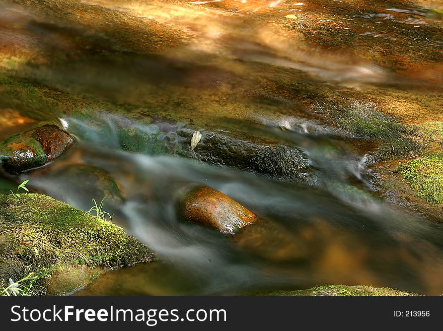 Moving water in a creek. Moving water in a creek.