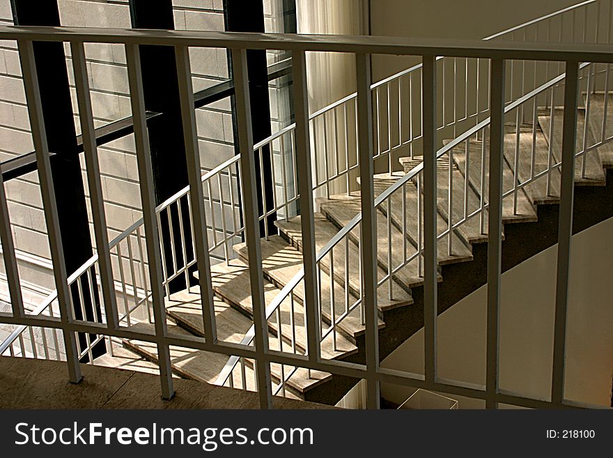 Curving staircase with handrails