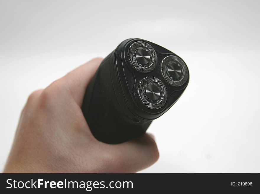 Man holding electric shaver. Man holding electric shaver