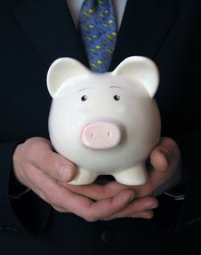 Businessman Holding A Piggy Bank Royalty Free Stock Images