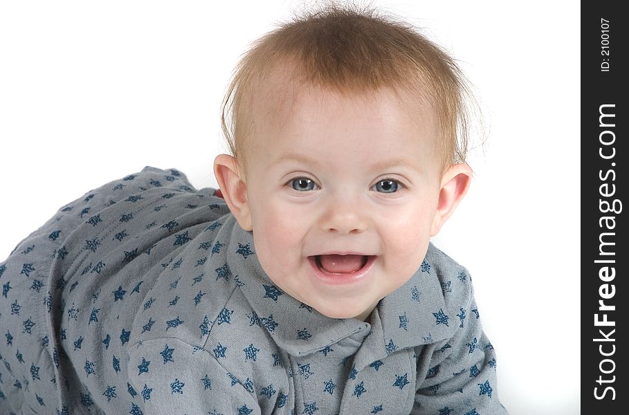 A cute baby in gray and blue stars on a white background smiling. A cute baby in gray and blue stars on a white background smiling