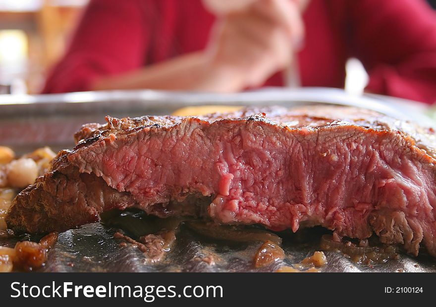 A slice view of a medium-rare beef steak. A slice view of a medium-rare beef steak.