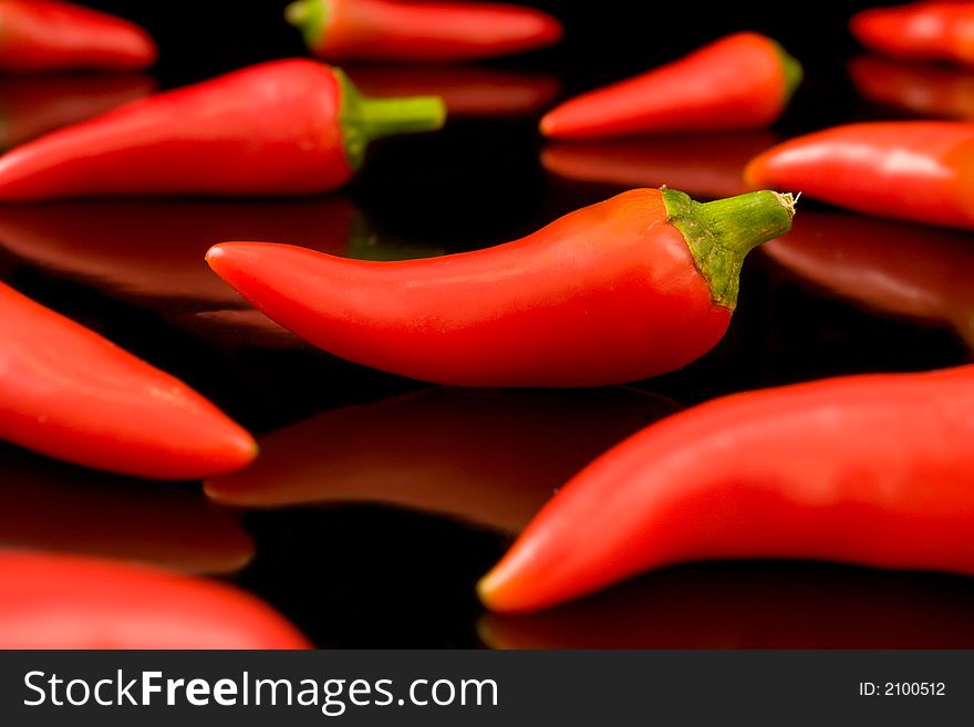 Chili Peppers Reflecting on a Black Background. Chili Peppers Reflecting on a Black Background.