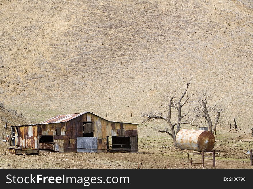 Old metal shed rusting in the sun in a rural valley of central California. Old metal shed rusting in the sun in a rural valley of central California