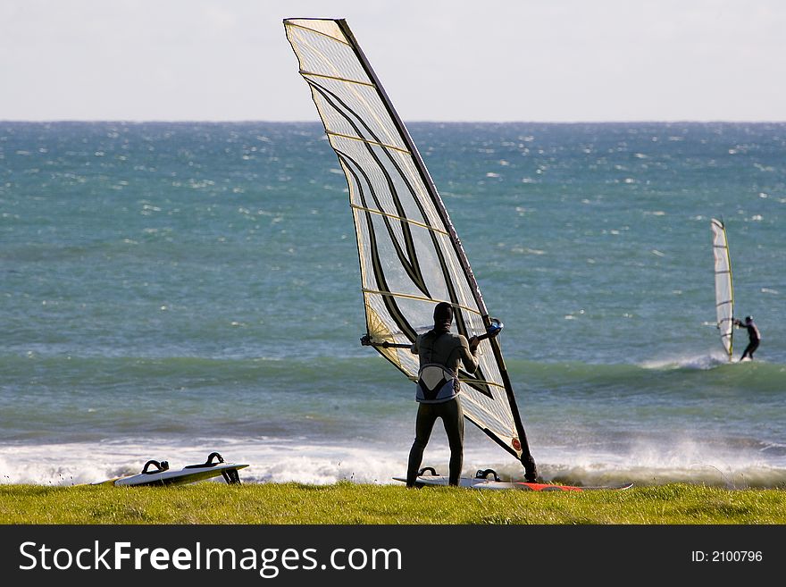 SHot of windsurfer getting ready to go in the ocean.