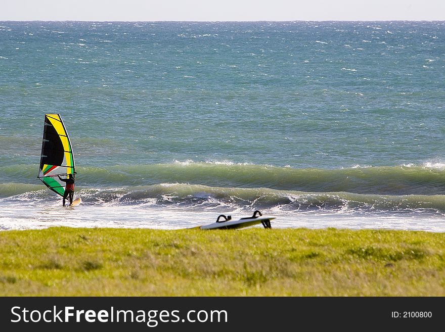 Shot of windsurfers on a central California beach.