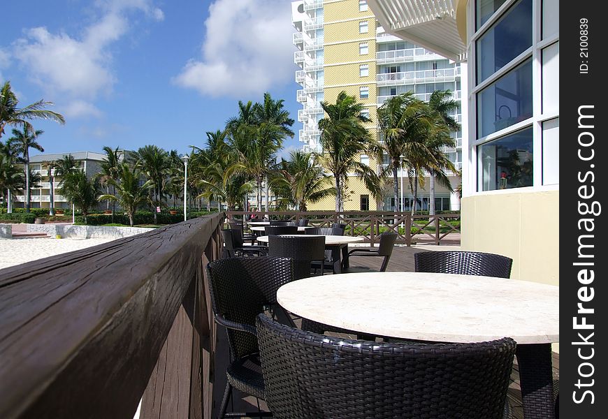 Tables and chairs outside of / at a peaceful beach front restaurant in The Bahamas islands. Tables and chairs outside of / at a peaceful beach front restaurant in The Bahamas islands